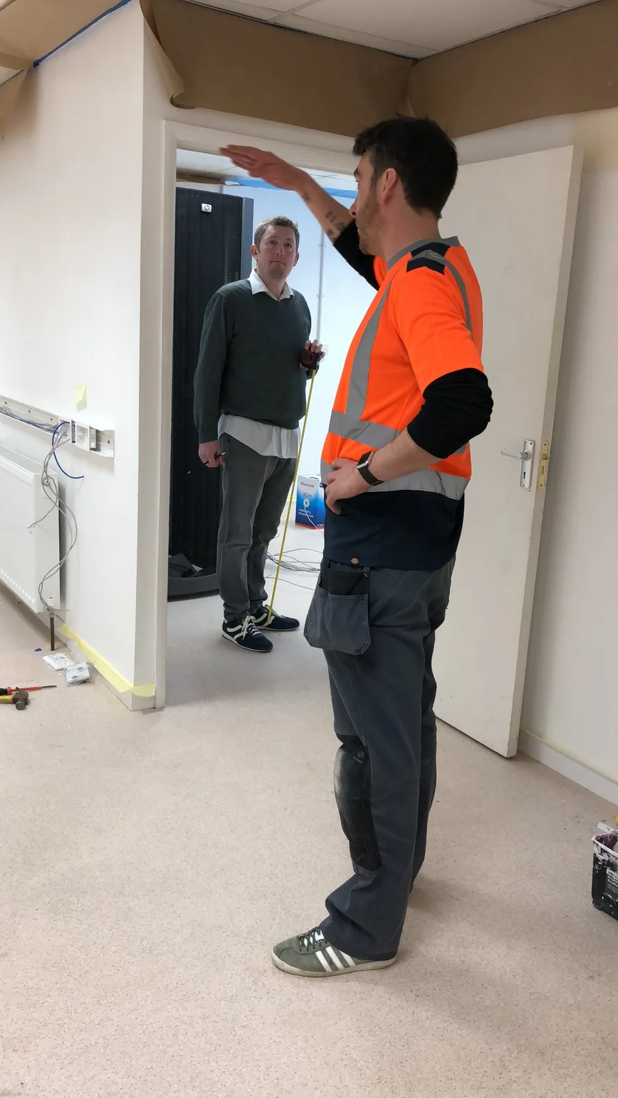 Robert Spencer measuring up for a structured cabling installation on a commercial site